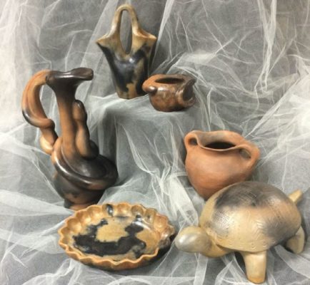 Select works of pottery by the Catawba Nation displayed on billowy fabric