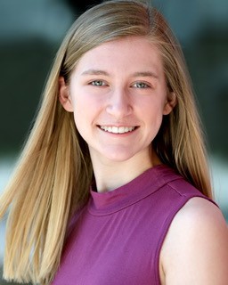 Headshot of Emily Allison, blonde female student with green eyes wearing a deep magenta sleeveless top.