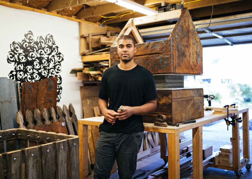 Fletcher Williams III stands in his art studio among works in progress.