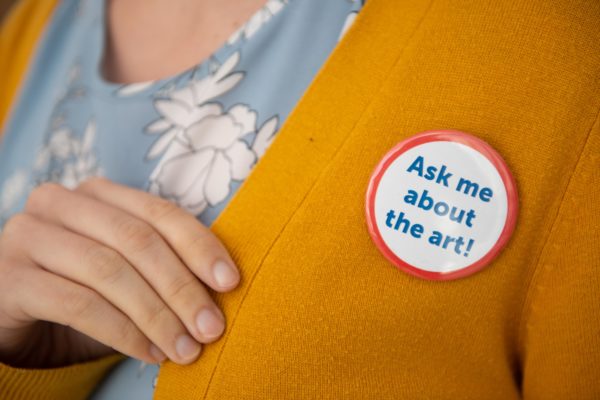 Image shows a person's label with a button that reads Ask me about the art!