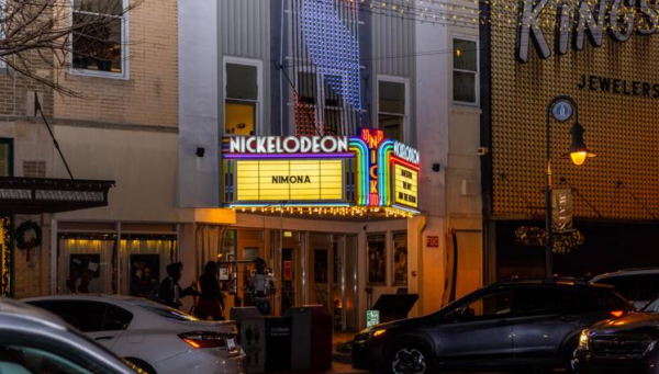Wide shot of The Nickelodeon Theater marquee at night. The sign reads "Nimora" for the screening of a film by that name.