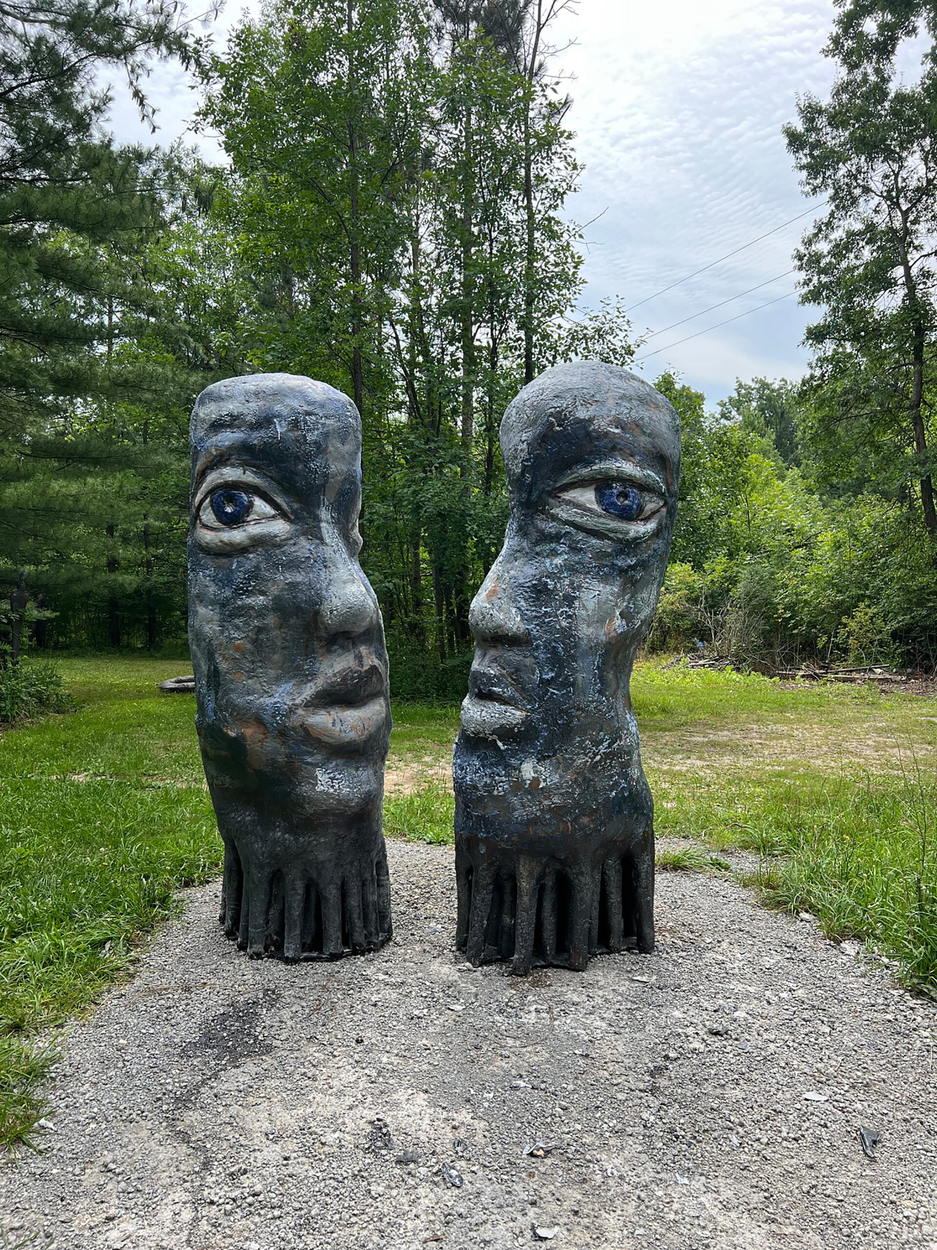 Mark Chatterley's outdoor sculpture, Human Collective, shows two large stone faces, each with one eye toward the camera