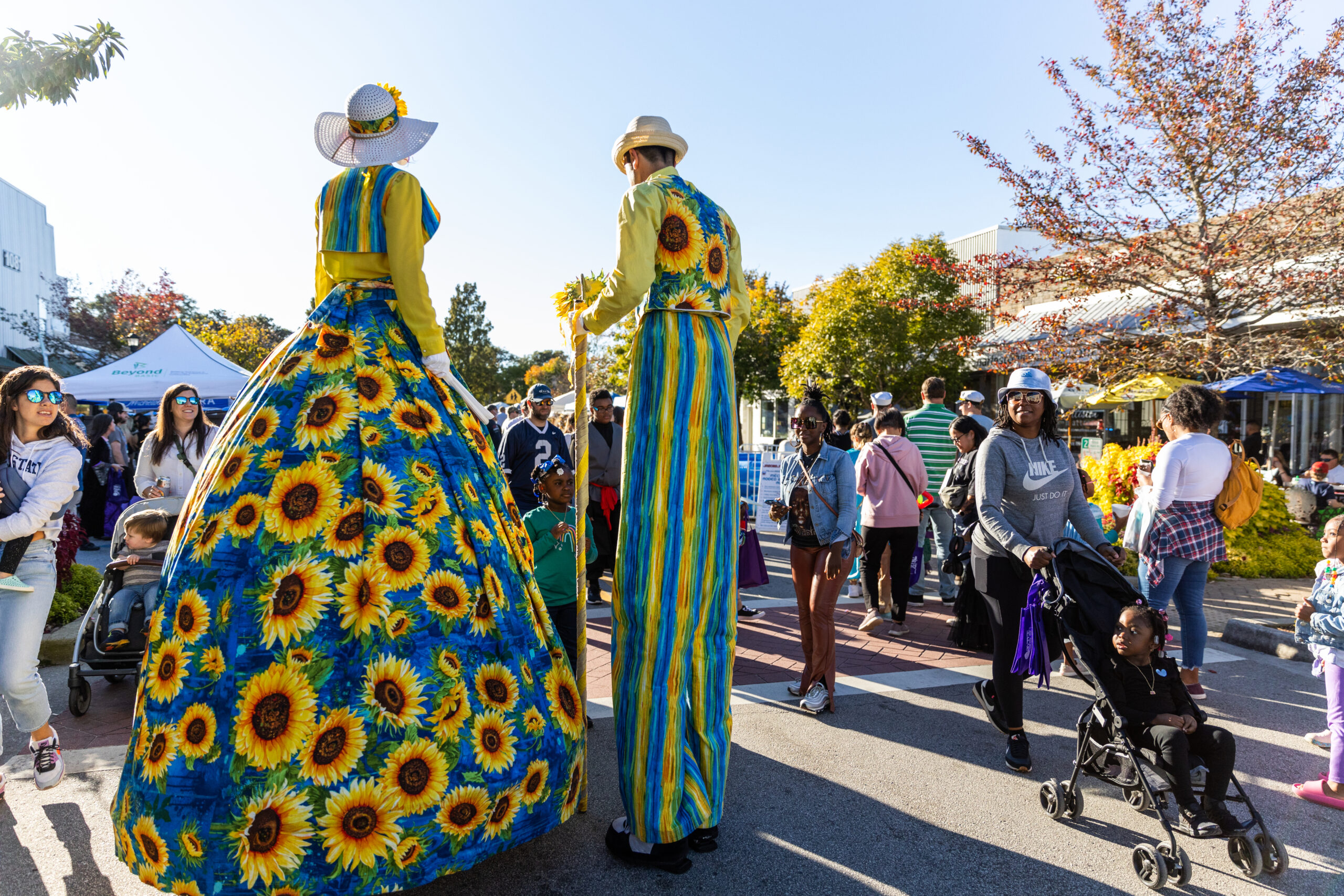 A man and woman on stilts at a street festival