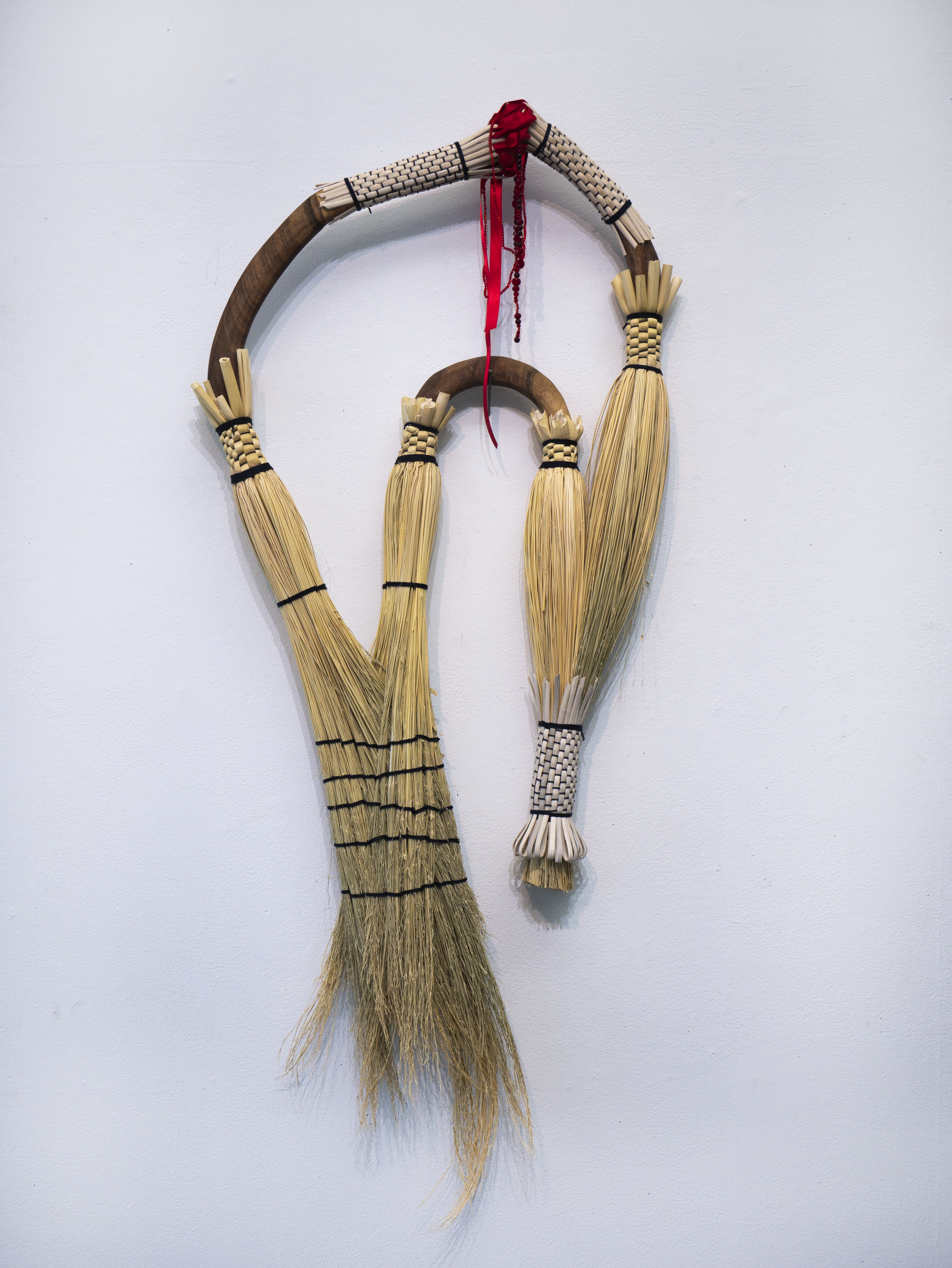 artwork by Jasmine Best; broomcorn, reed, cord, walnut, beads, ribbon
