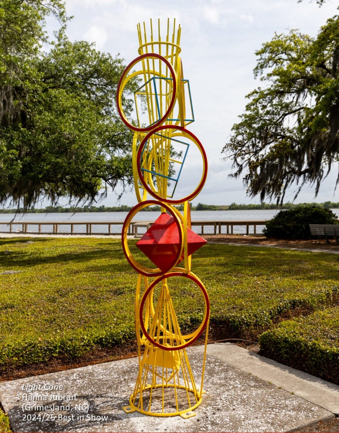 Abstract outdoor sculpture in vibrant primary colors with rings and geometric shapes.