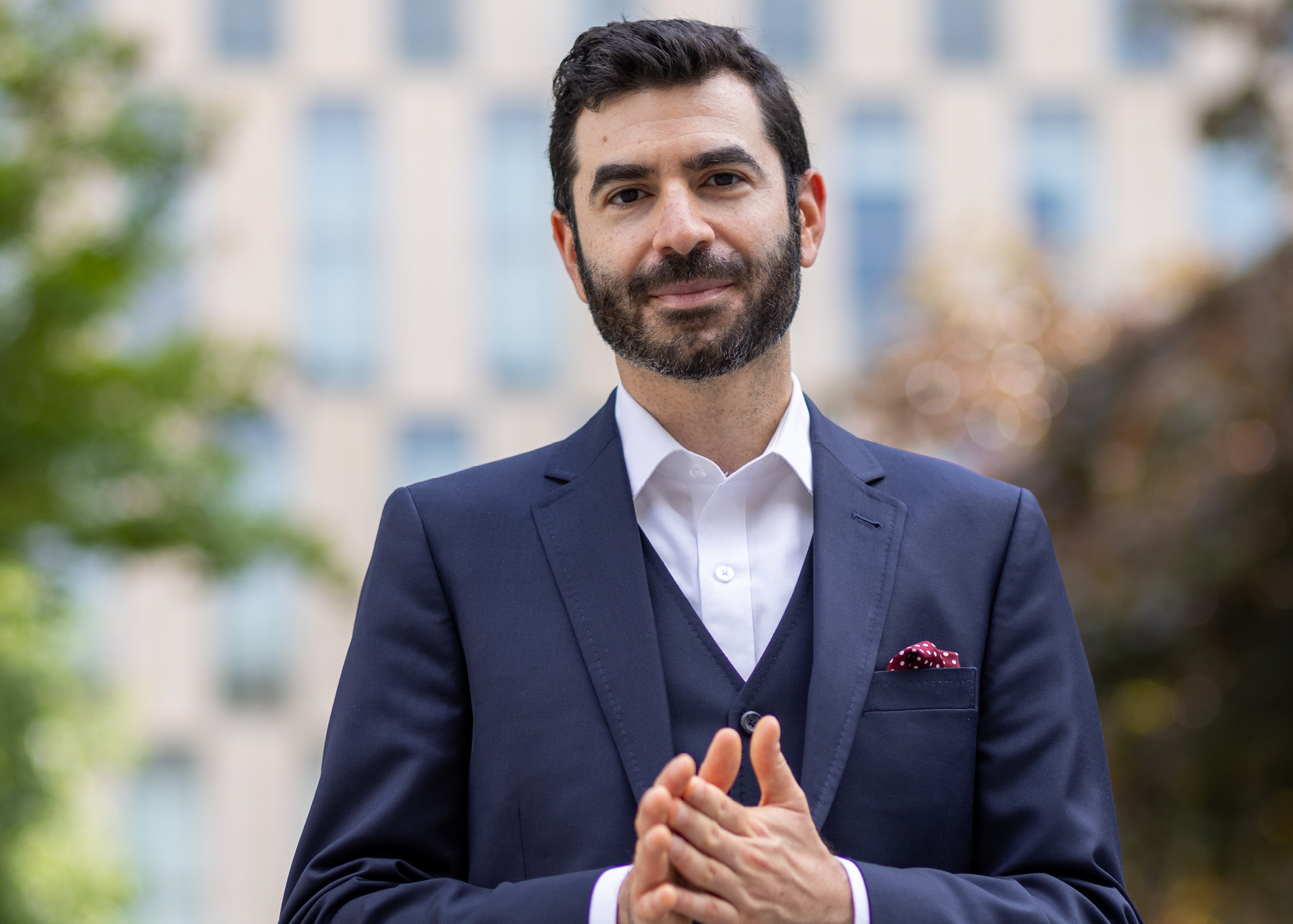 Pianist Michael Stephen Brown has dark hair and dark facial hair. He stands outdoors in a suit.