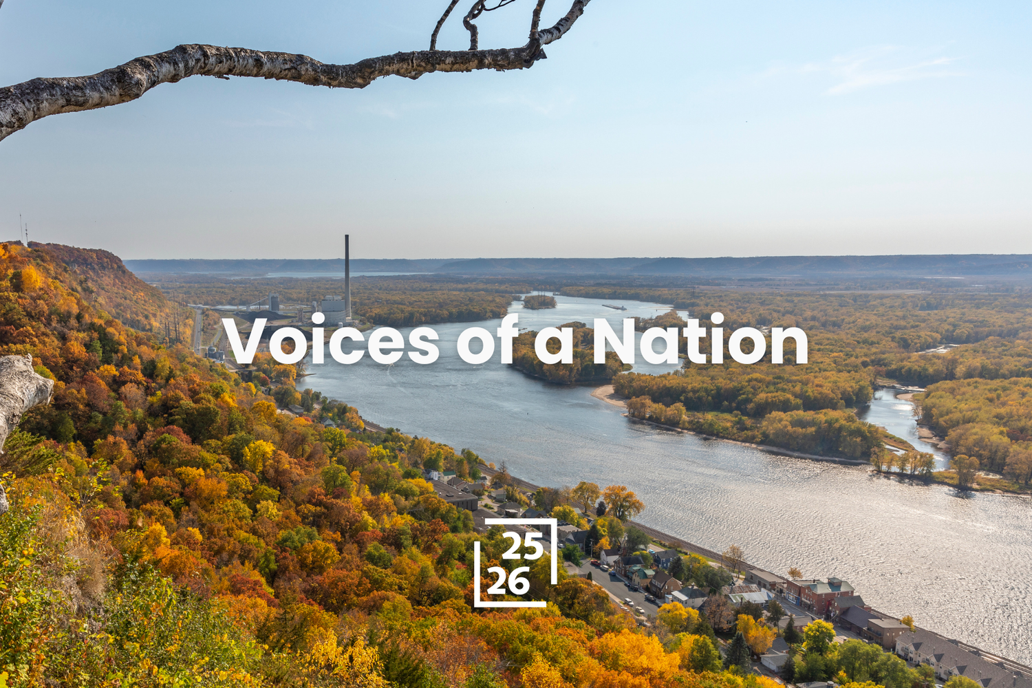 Scenic view of a wide river winding through fall trees.