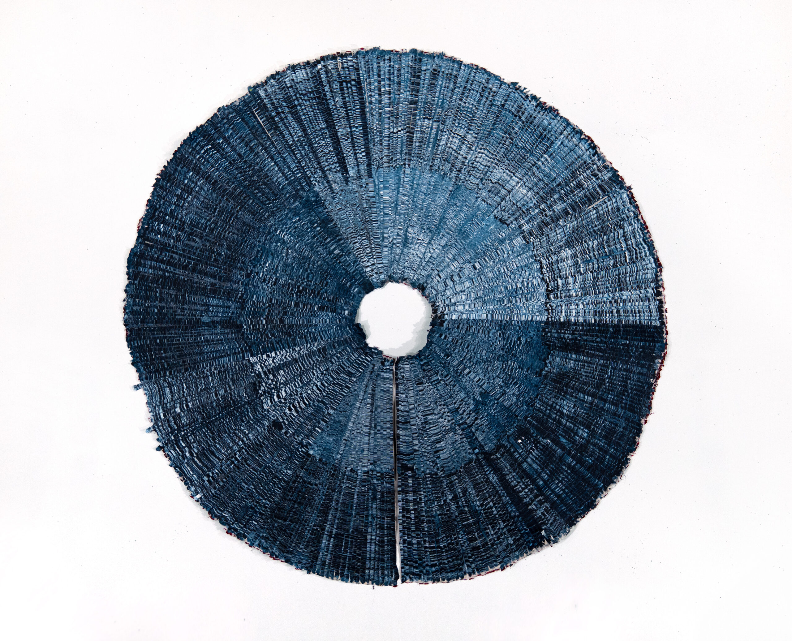 "The Divine Eye," Artwork by Kenny Nguyen. A blue pleated circle with a small opening in the middle.