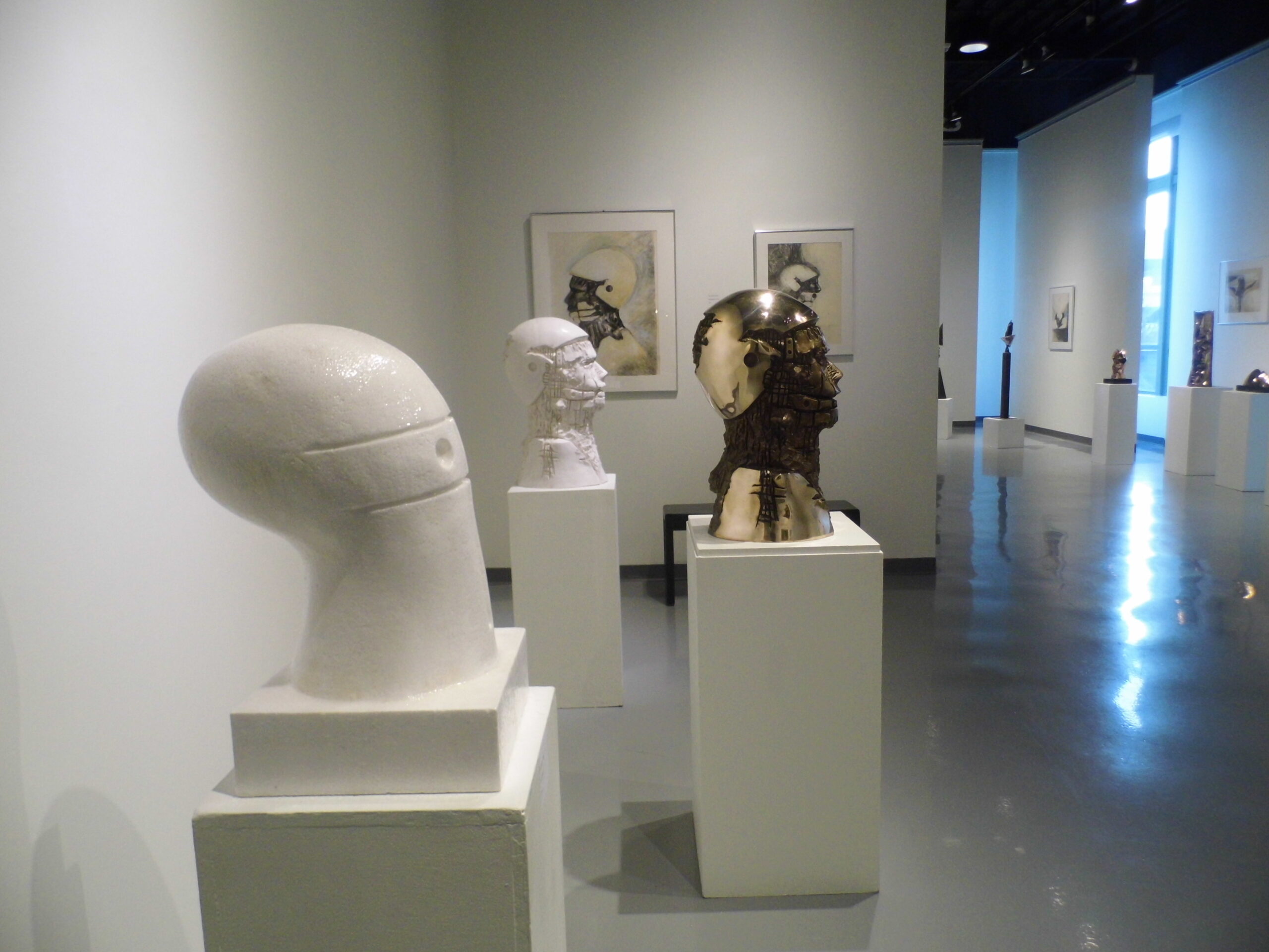Sculptures and drawings by Winston Wingo, variations on a bust of a human head.