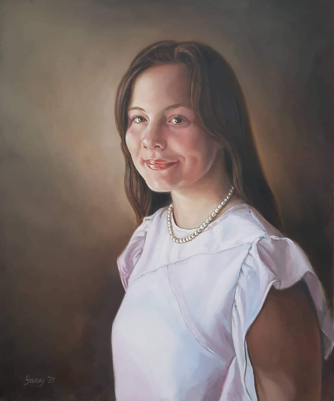 Three quarter view portrait of a young woman with long dark hair.