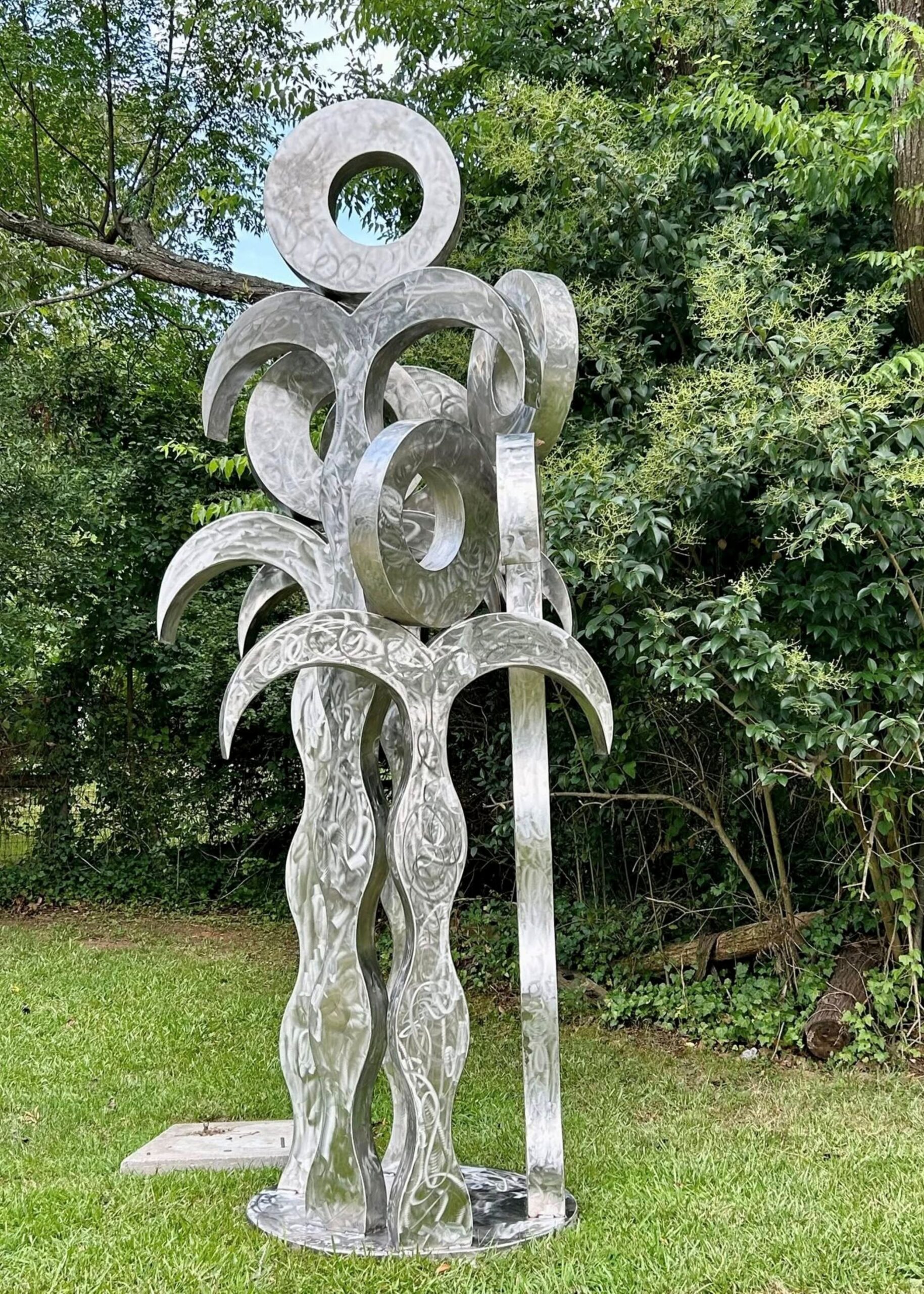 "Five Sisters," metal sculpture by Bob Doster. Five stylized palm trees, each with a circle on top.