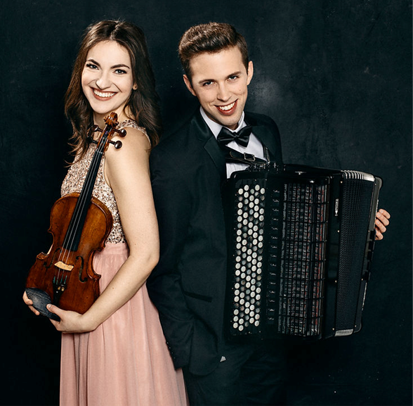 A young man and woman smile in formalwear holding their violin and accordion.