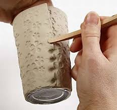 Hands shown building a clay slab container.