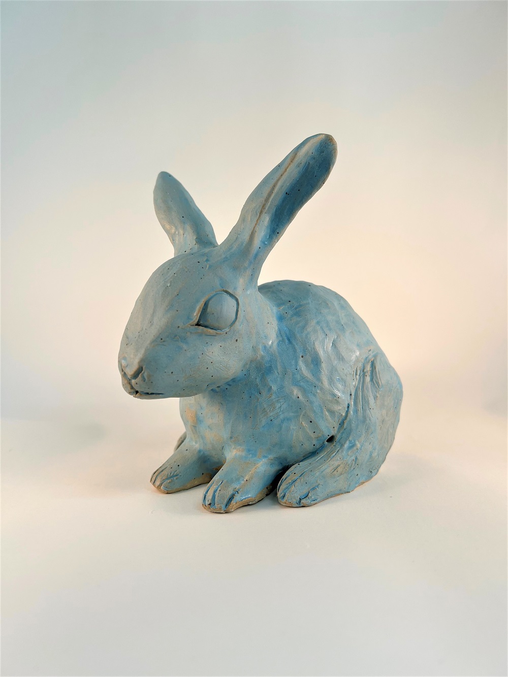 A sculpted rabbit with blue glaze.