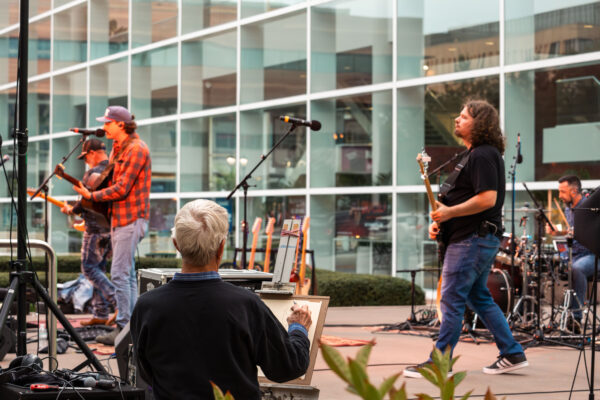 A country rock band on stage outside.