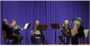 A brass quintet plays onstage.