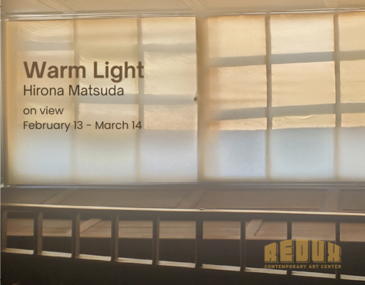 Interior of a wooden room with large paned windows, covered in off-white canvas, filtering sunlight.