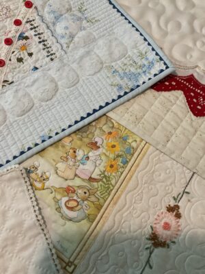 Quilts show flowers, buttons, and a scene of cartoon bunnies cooking in dresses with aprons.