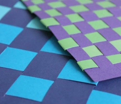 Blue, purple, and green construction paper woven in large blocks.