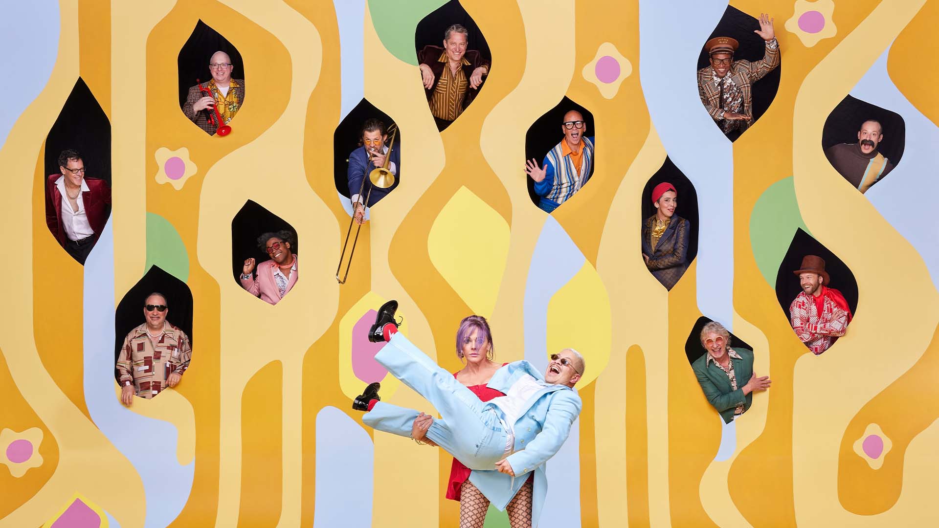 Happy people in a yellow pop-art style wall, and a woman holding a man in a cradle-style lift.