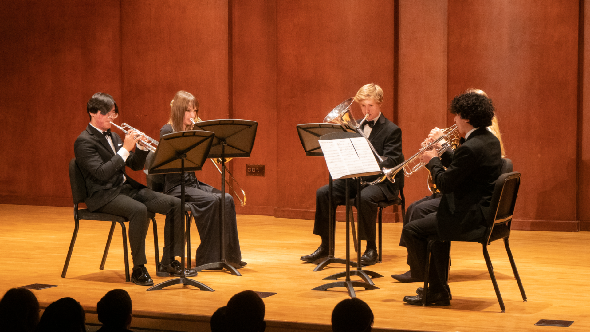 Student brass quintet performs onstage.