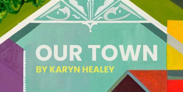 Painted panel of bright blocks of color and a white gabled rooftop.