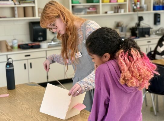 A teaching artist working with student