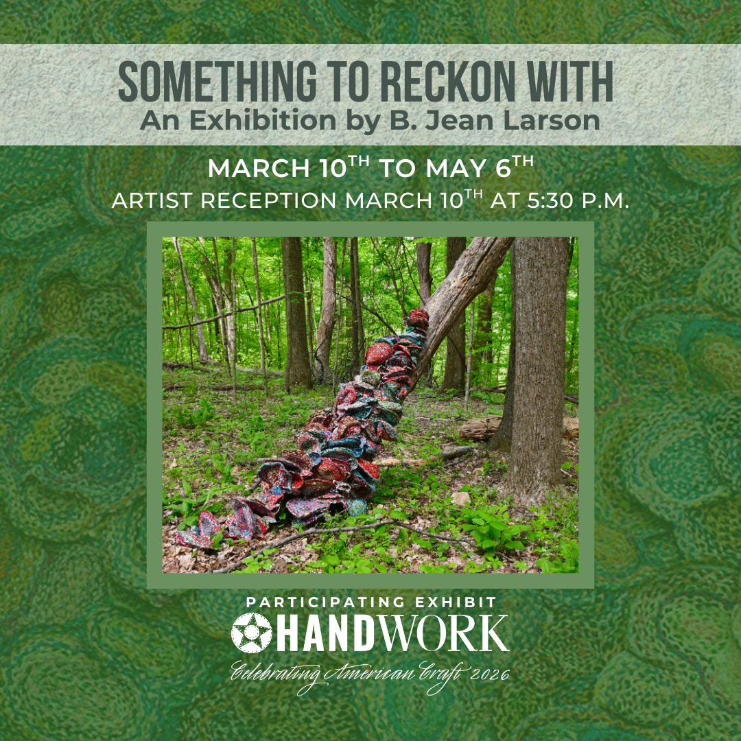 A fallen tree in a forest is covered by 3 dimensional curved pieces of cloth in vibrant colors.