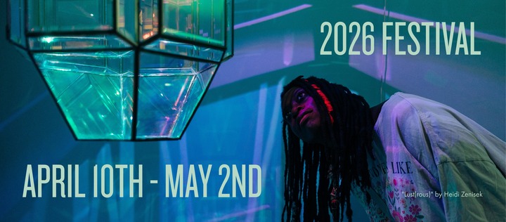 A person presenting as Black looks closely at a hanging 3d artwork of glass and lights.