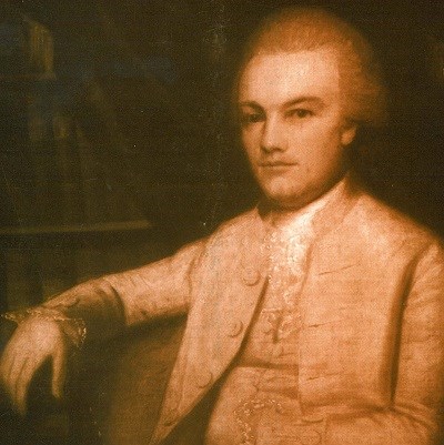 Formal waist-up portrait of a young man from the late 18th century, set against a dark background.