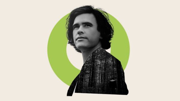 Man with full dark hair, staring at something above and behind the viewer.
