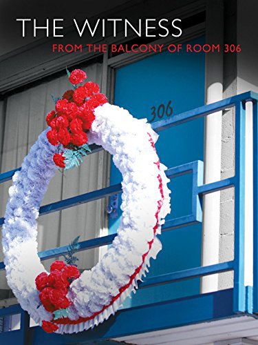 Exterior of motel room 306. A large white and red wreath of carnations hangs on the balcony.