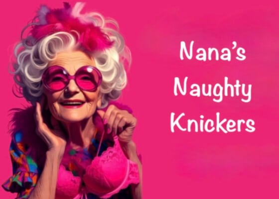 An older woman with large white curls, wearing large pink sunglasses and holding a lacy pink bra.