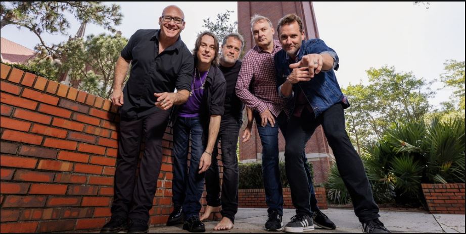 5 men look downward toward the viewer with friendly expressions.