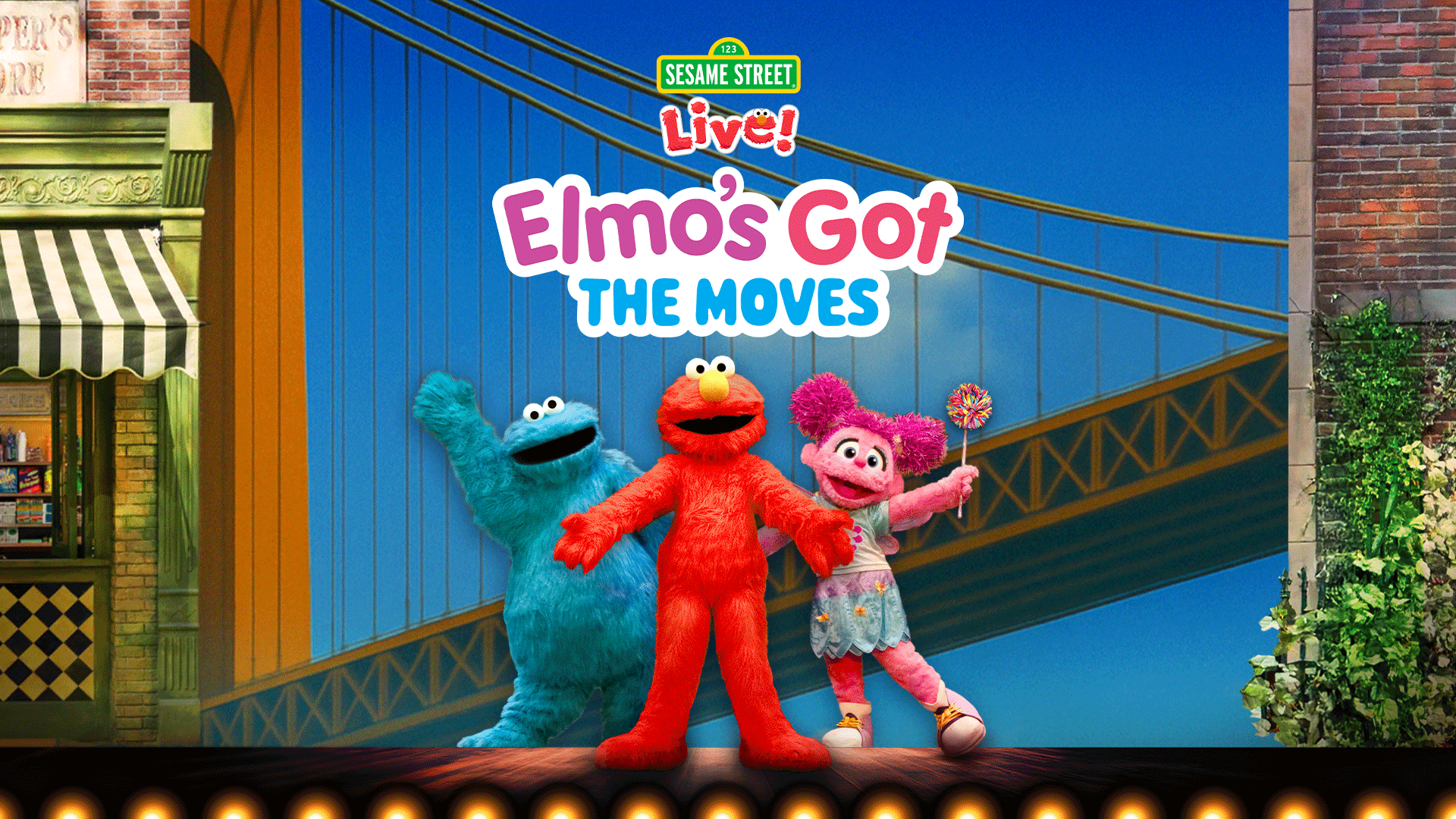 Muppets Cookie Monster, Elmo, and Abby Cadabby pose in front of a New York City bridge.