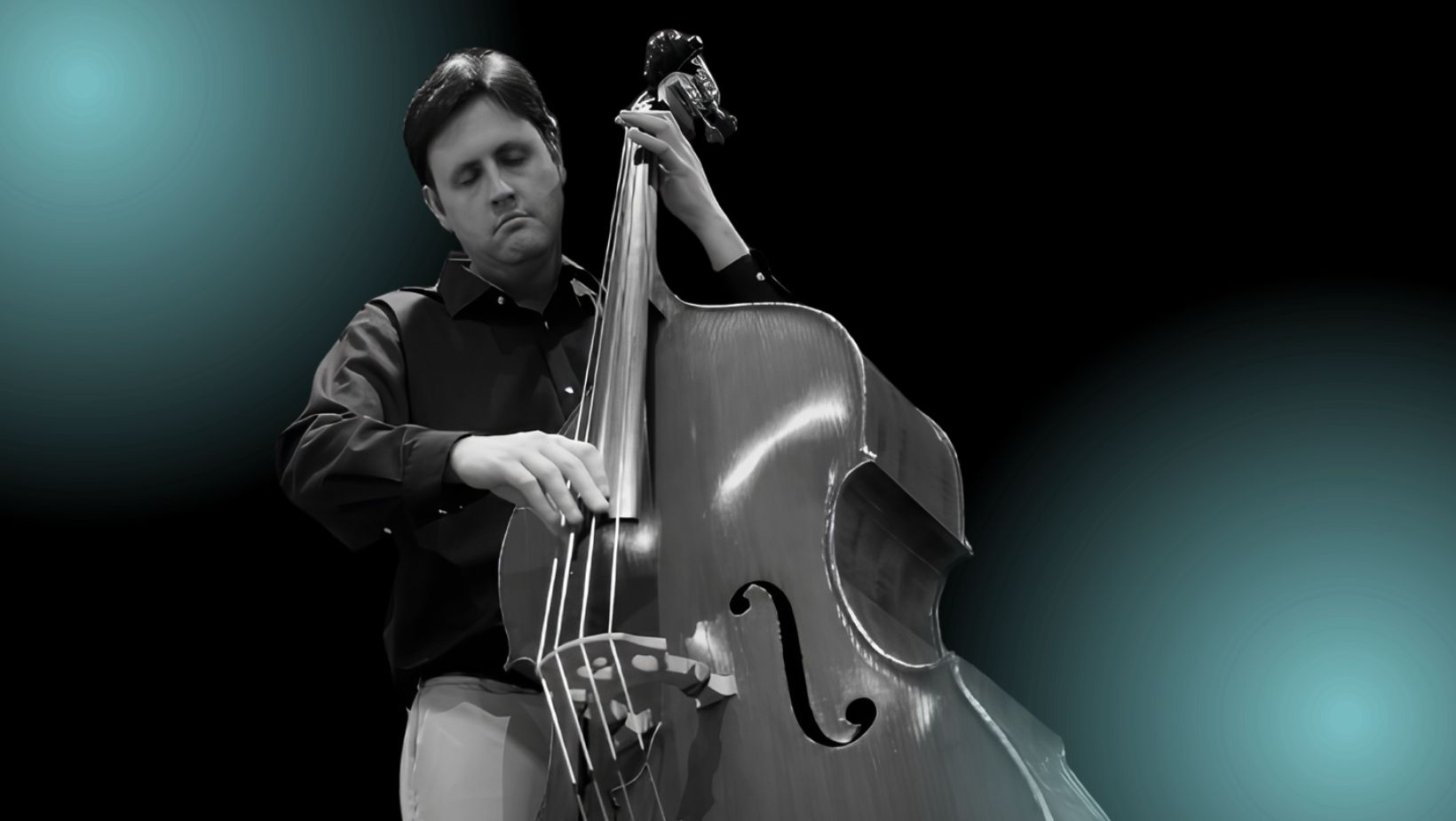 A man with dark hair plays upright bass with his eyes closed.