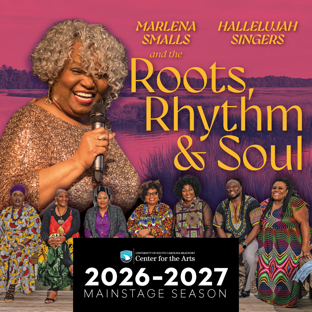 A Black woman sings into a hand-held microphone. 6 Black women and 1 Black man are seated in a row.