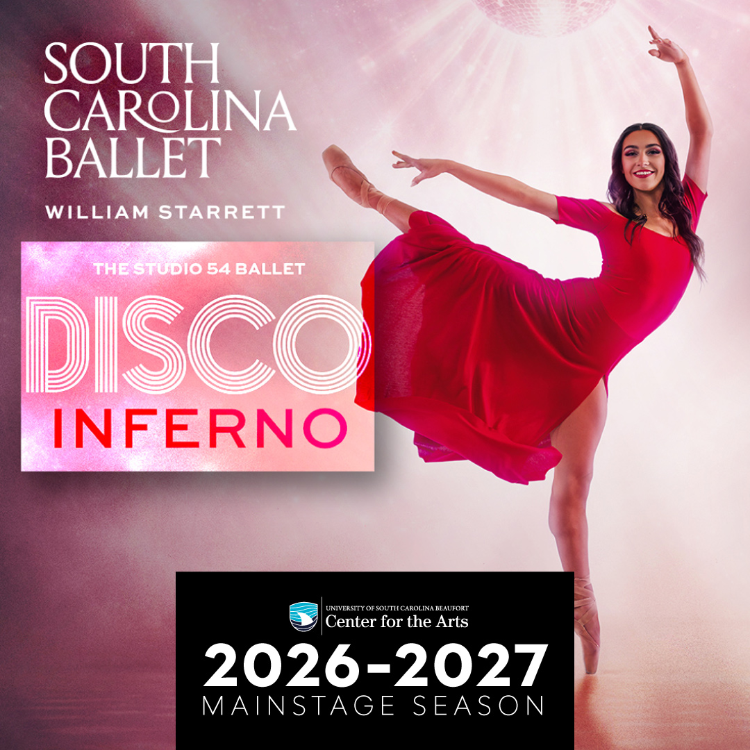 A ballet dancer with long dark hair does an arabesque en pointe in a red dance dress.