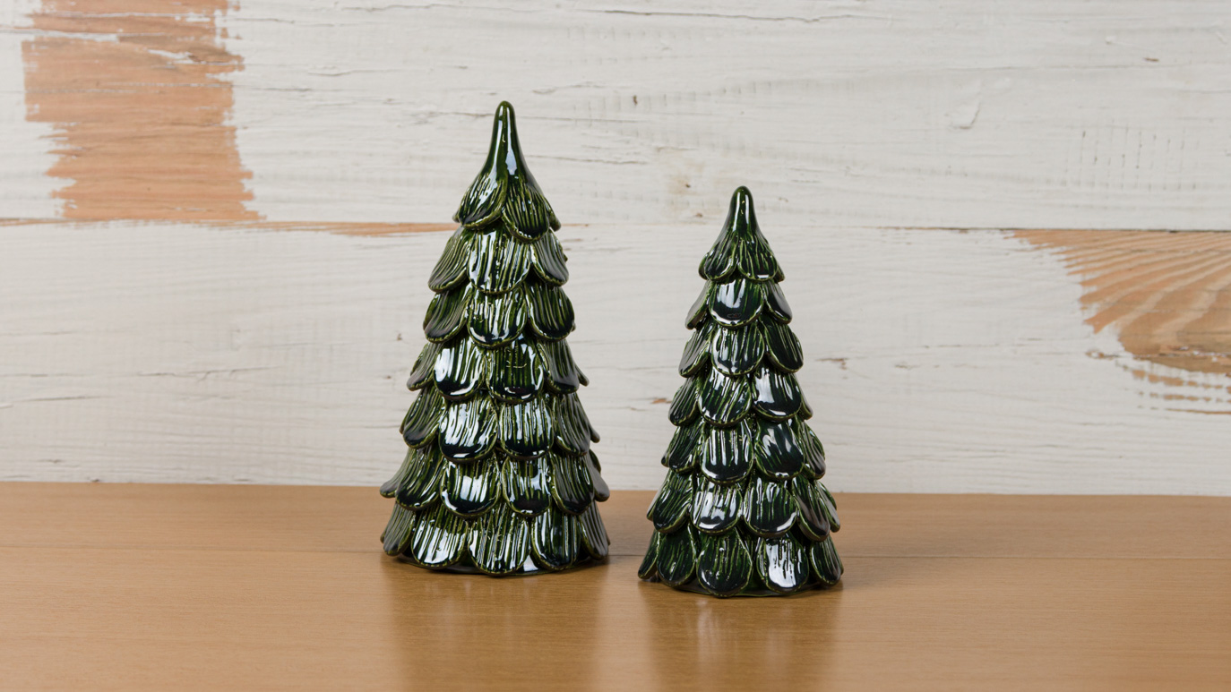 Two ceramic three-dimensional evergreen trees with dark green shiny glaze.