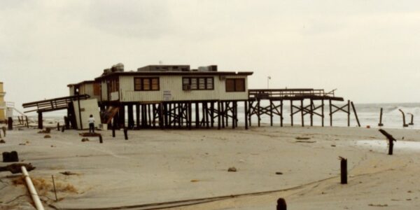 Photograph of a beach building damaged by a hurricane.