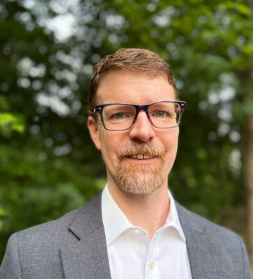 Headshot of Jay Owens, a white male wearing glasses.