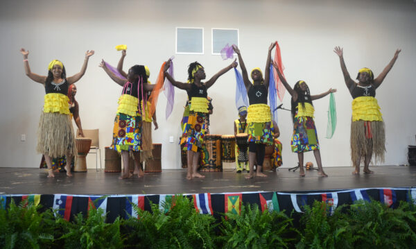 Six members of a black, all-female dance and music group on stage.